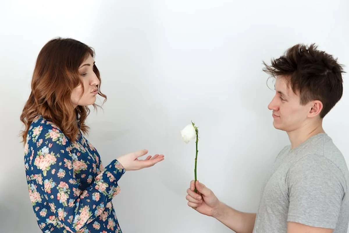 Mężczyzna daje kobiecie złamany kwiat